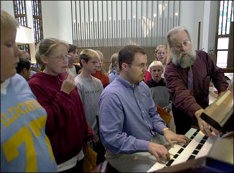 Michael Barone demonstrates the different stops of the Austin organ with Minneapolis organist Daniel Schwandt seated at the bench.
