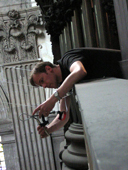 [Chris Frommen leans over the edge of the organ loft at Saint Sulpice to set up microphones for the Widor Mass recording session.]